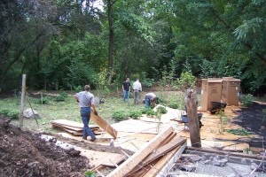 Volunteers clearing debris from a yard.